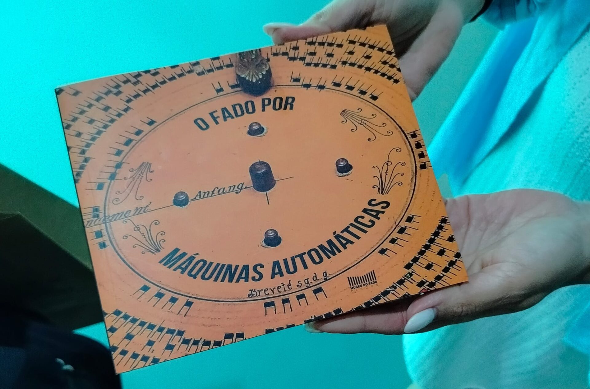 Holding a vinyl record with both hands.