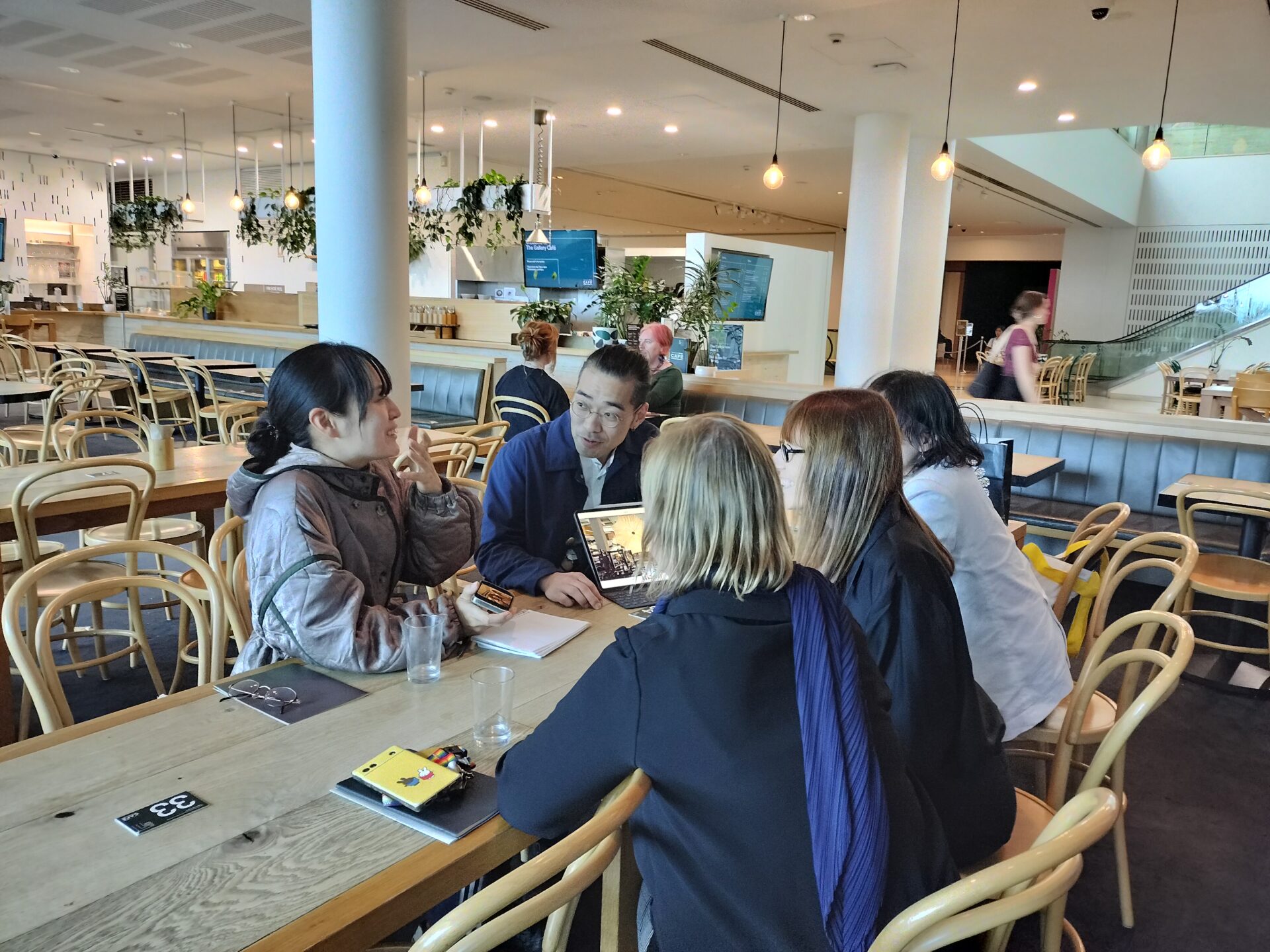 Endo, Arai, Melanie, and Director Maud having a meeting in the café space inside the AGNSW.