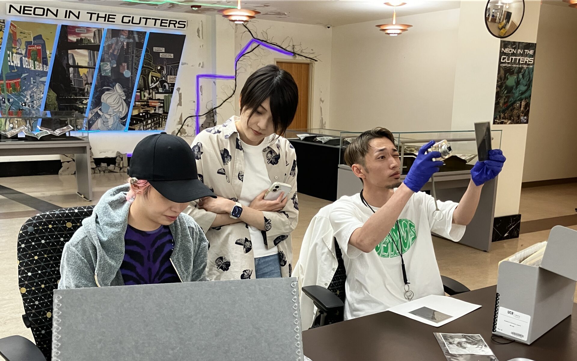 MES and Tsukamoto searching through documents and materials.