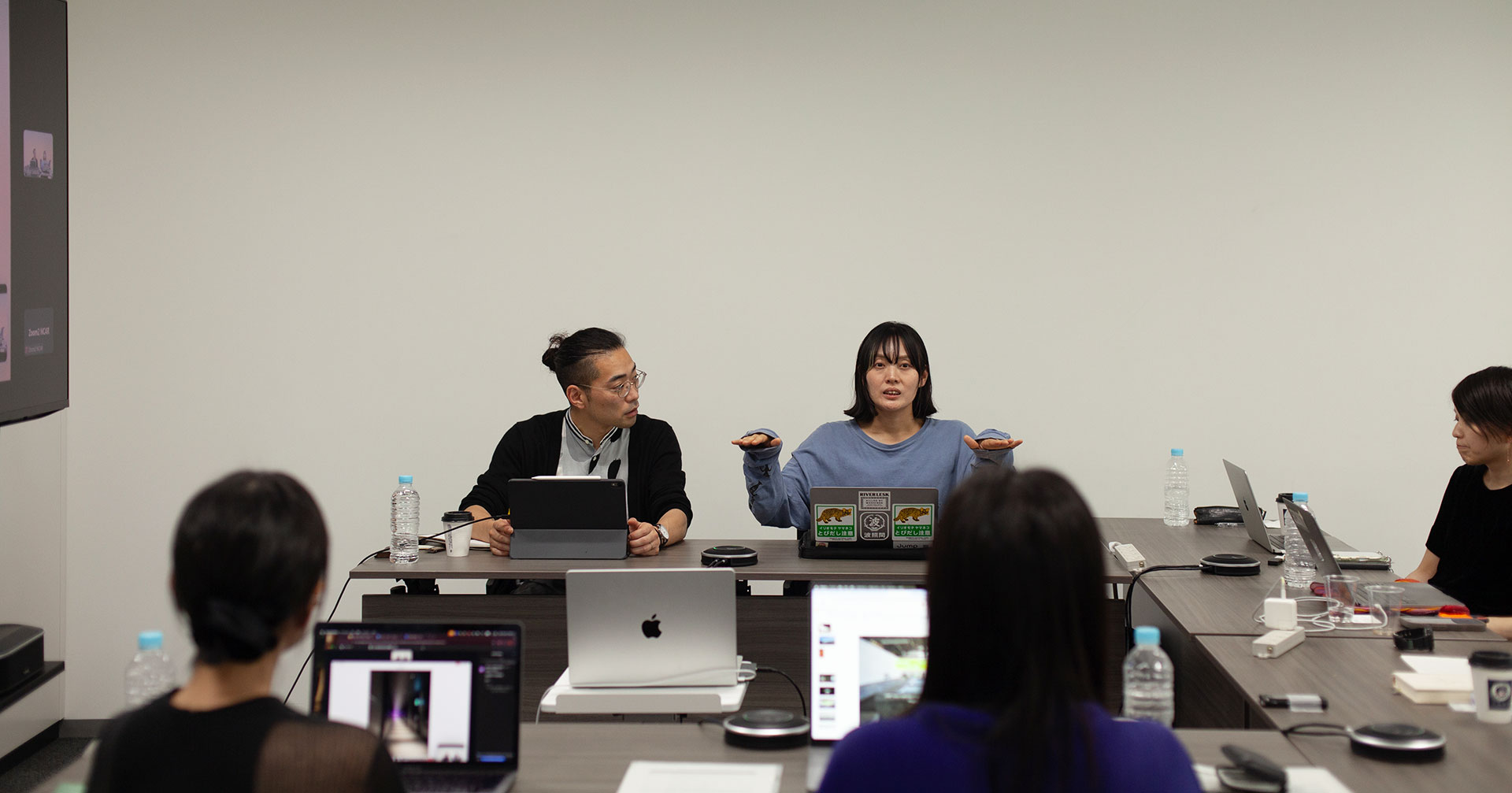 Endo and Arai giving a presentation